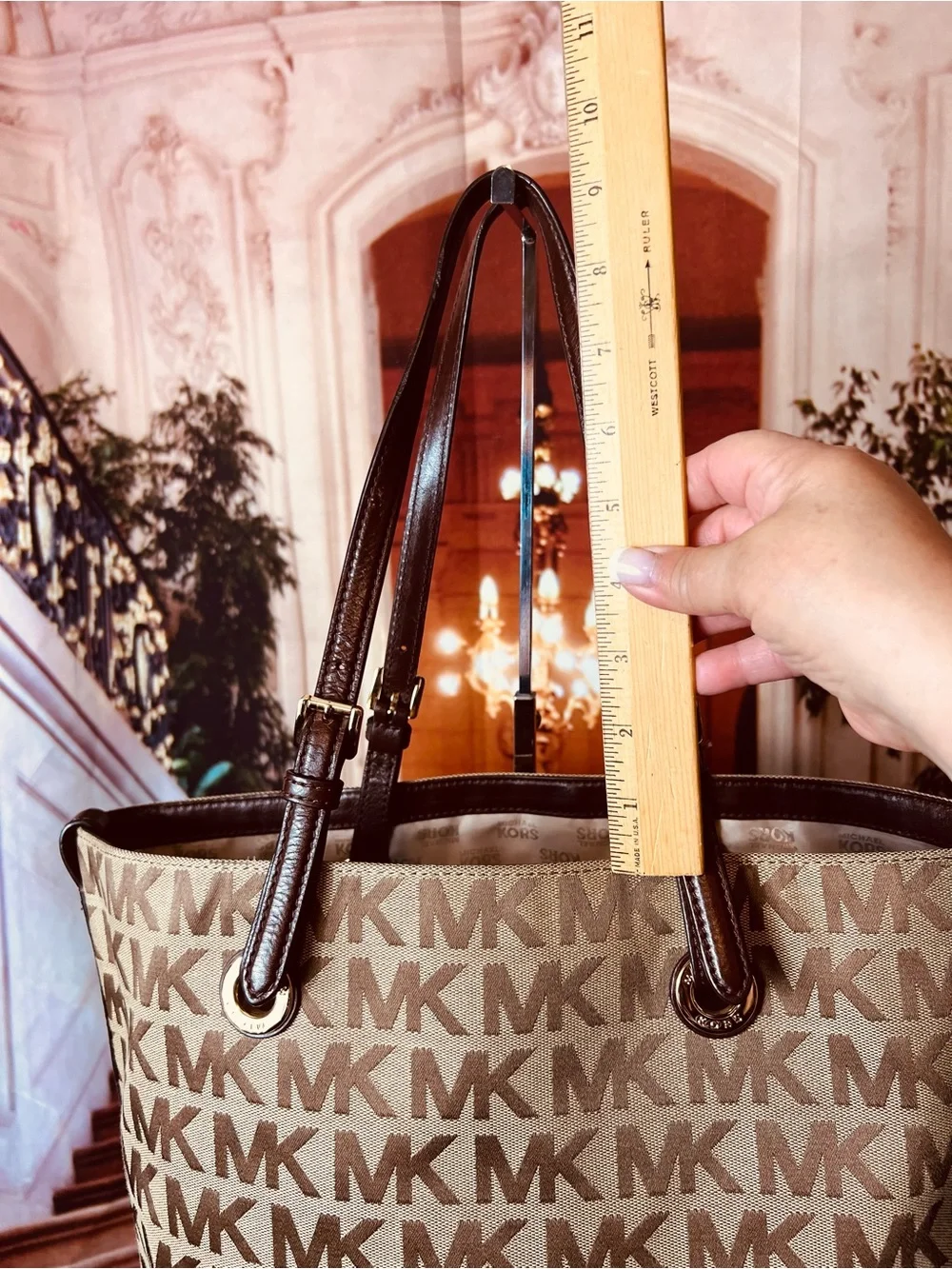 Michael Kors Jet Set tote features monogram canvas, contrasting leather straps